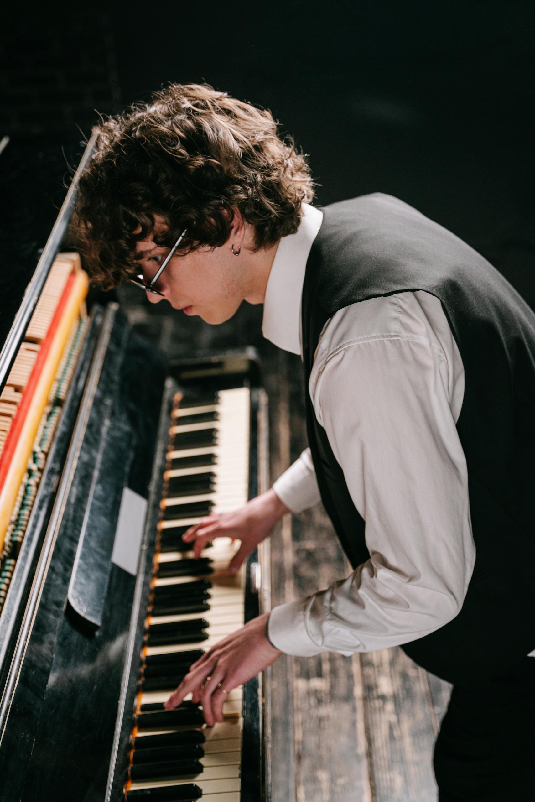 Man in Black Waistcoat Playing Piano